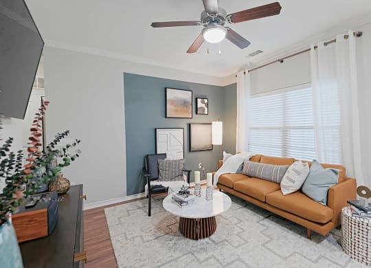 a living room with a couch and a ceiling fan