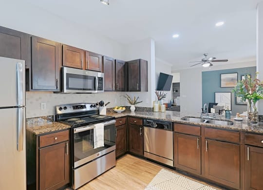 a kitchen with stainless steel appliances and wooden cabinets