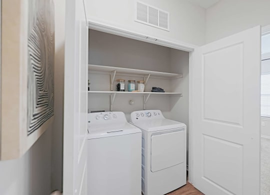 a small laundry room with a washer and dryer in it