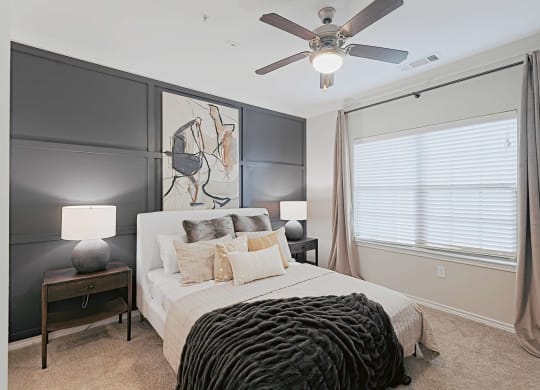 a bedroom with a bed and a ceiling fan