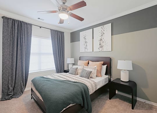a bedroom with a bed and a ceiling fan