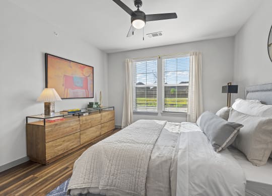 a bedroom with a large bed and a ceiling fan