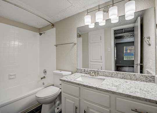 a bathroom with a sink toilet and bathtub
