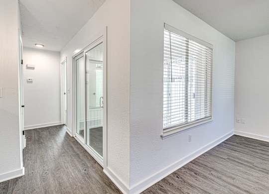 A room with a window and a sliding glass door.