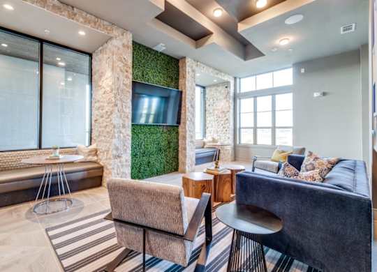 A living room with a couch, a chair, and a table.