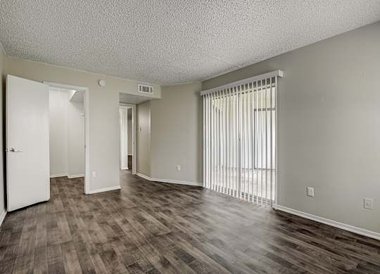 an empty living room with a hardwood floor