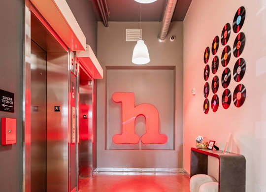 A hallway with a large letter h on the wall.