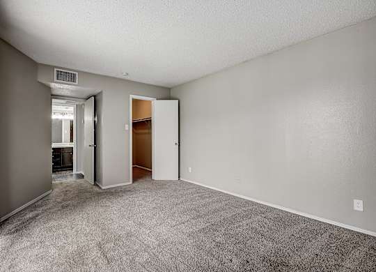 a bedroom with gray carpet and white walls