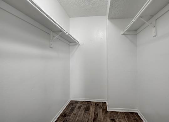 an empty room with white walls and a wooden floor