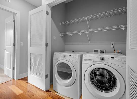 a washer and dryer in a laundry room with a closet