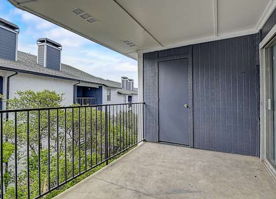 a large patio with a door that leads to the backyard