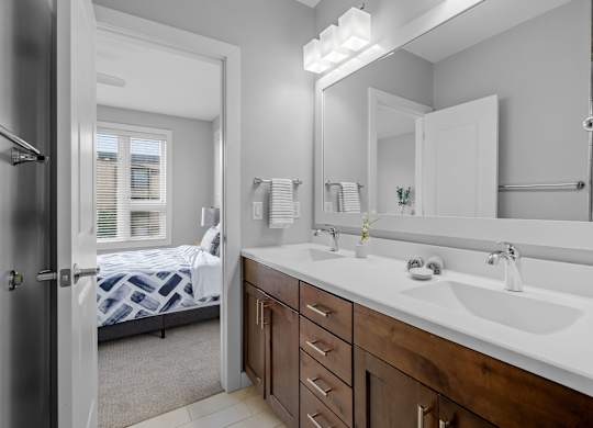 a bathroom with a large mirror and a sink