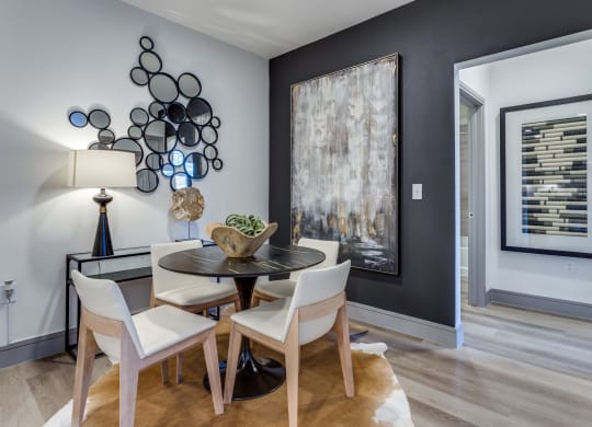 a dining room with a table and chairs
