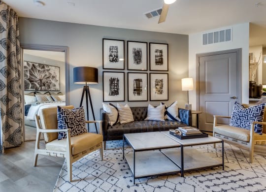 a living room with a couch and chairs and a coffee table