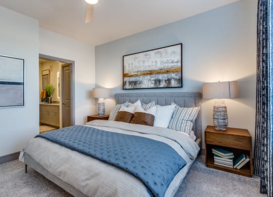 a bedroom with a large bed and a view of the bathroom