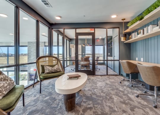 a conference room with a table and chairs and large windows