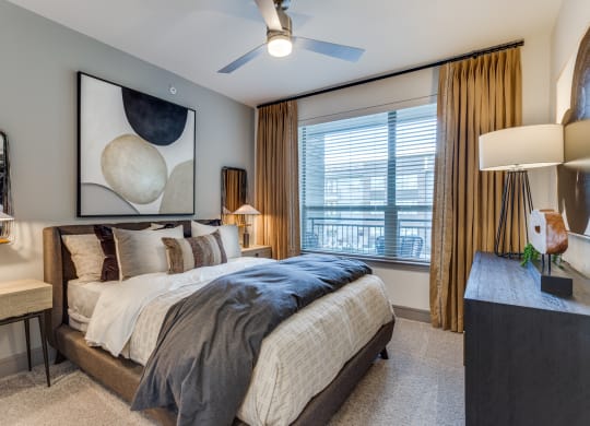 a bedroom with a large bed and a ceiling fan