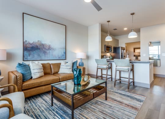 a living room with a couch and a glass coffee table
