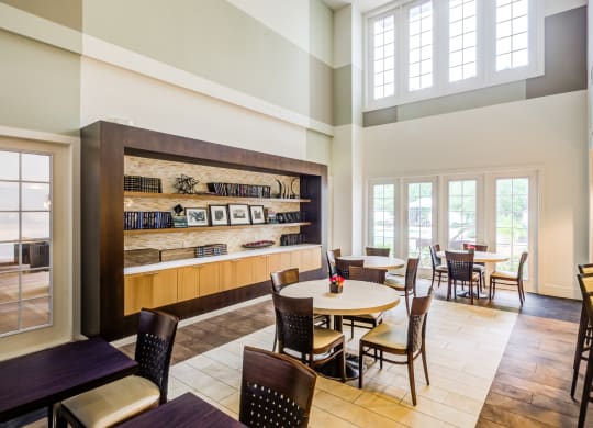 a dining room with tables and chairs and a large window