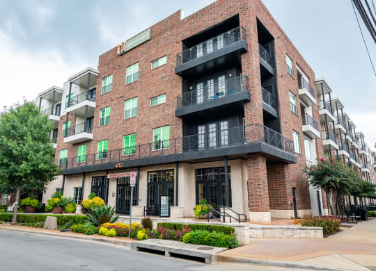 a red brick apartment building on a city street