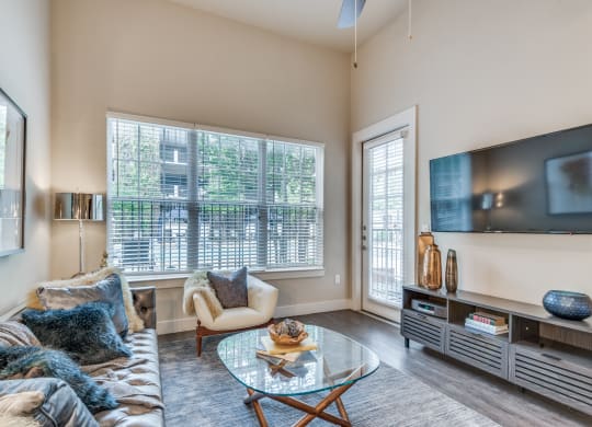 a living room with a couch and a glass coffee table
