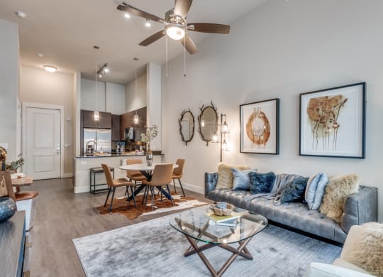 a living room with couches and a glass coffee table