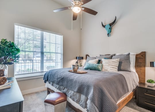 an attic bedroom with a large bed and a ceiling fan