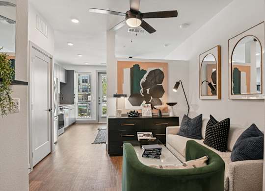 A modern living room with a green sofa and a black coffee table.