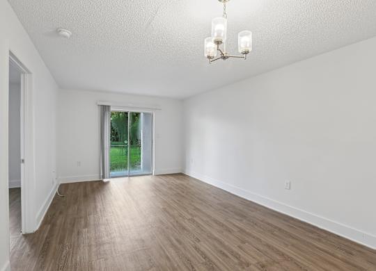 A room with wooden floors and a chandelier.
