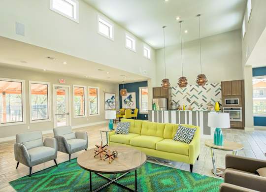 A living room with a yellow couch and a coffee table.