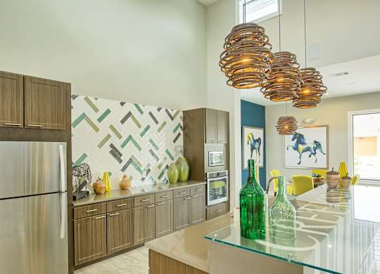 A modern kitchen with a glass counter top and wooden cabinets.