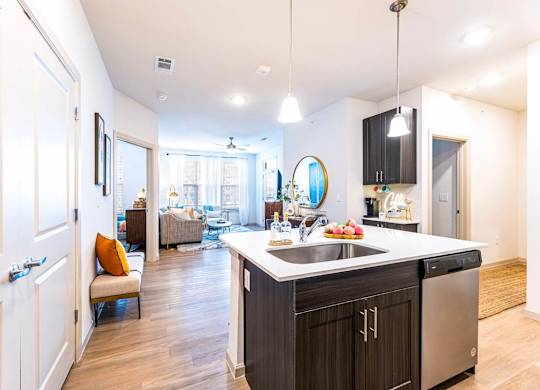 A kitchen with a sink and a counter.