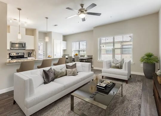 A modern living room with a white couch and a glass coffee table.