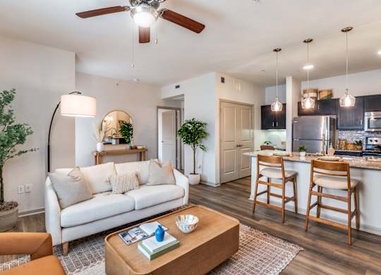 A living room with a white couch and a wooden coffee table.