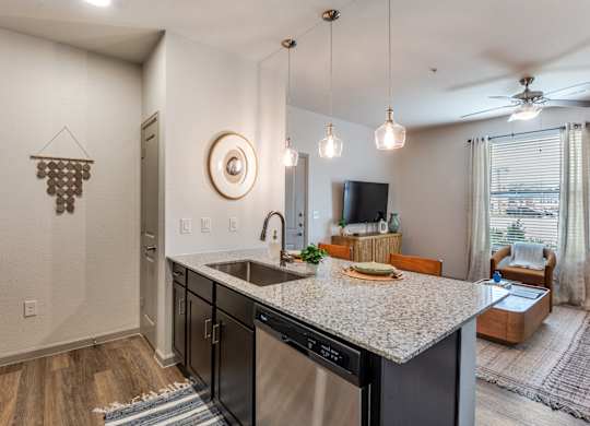 A modern kitchen with a large island and stainless steel appliances.