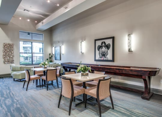 a dining room with tables and chairs and a pool table