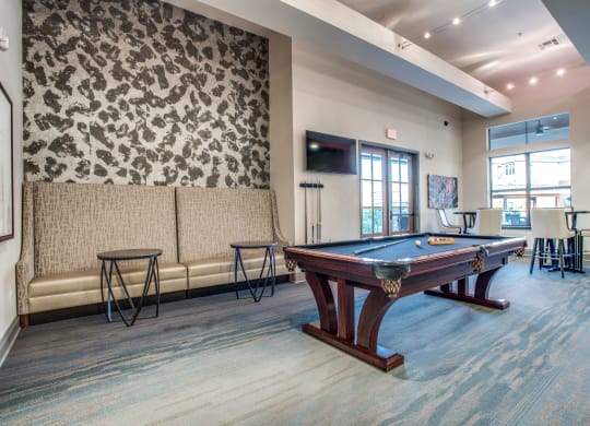 a games room with a pool table and a tv