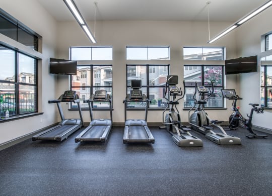 a gym with cardio equipment and windows at the briggs building
