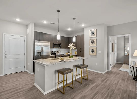 A modern kitchen with a bar stool and a countertop.