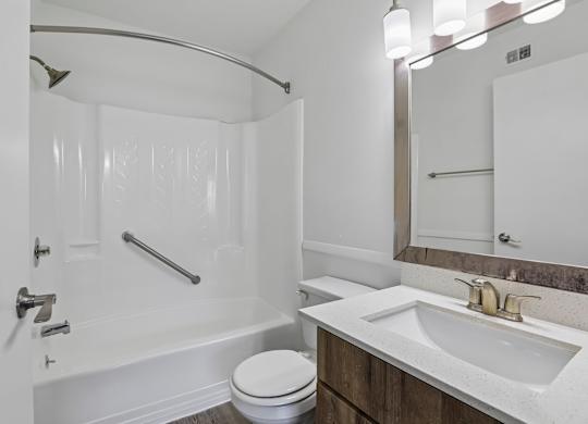 A white bathroom with a toilet, sink, and bathtub.