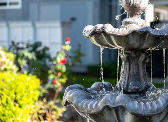 A water fountain with water flowing from it.