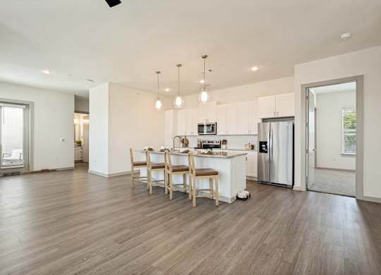 A kitchen with a dining table and chairs in the middle of the room.