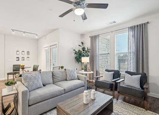 A living room with a grey couch and a wooden coffee table.