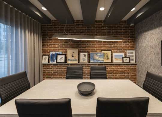 A conference room with a long table and chairs.
