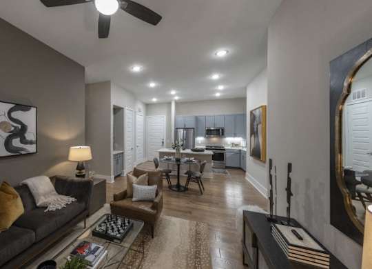 A modern living room with a grey couch and a rug.