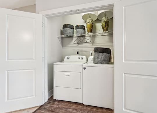 A white bathroom cabinet with a sink and a cabinet door open.
