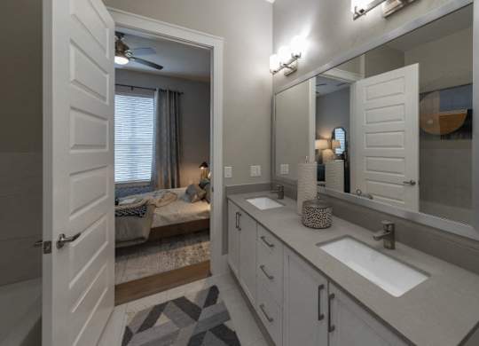 A bathroom with a white sink and a mirror.