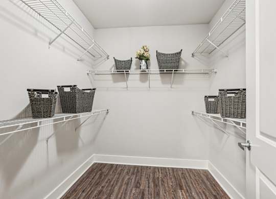 A white pantry with shelves and baskets.