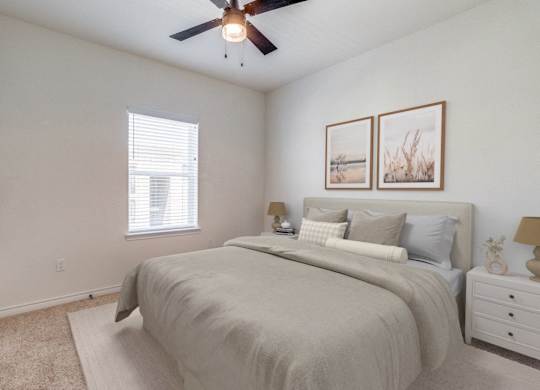 an expansive bedroom with a large bed and a ceiling fan