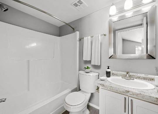 a white bathroom with a sink and a toilet